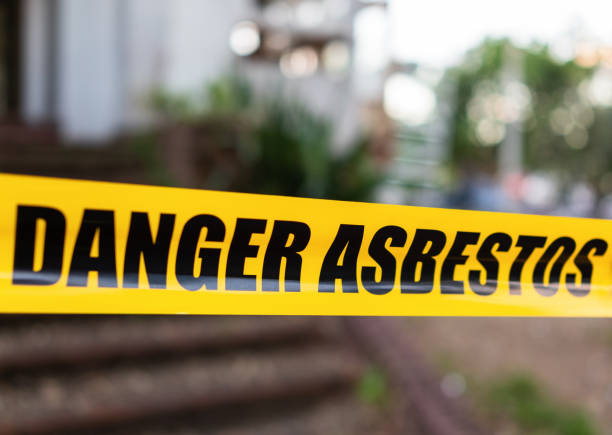 Danger asbestos warning tape creating a barrier, signifying the importance of professional asbestos removalist services.