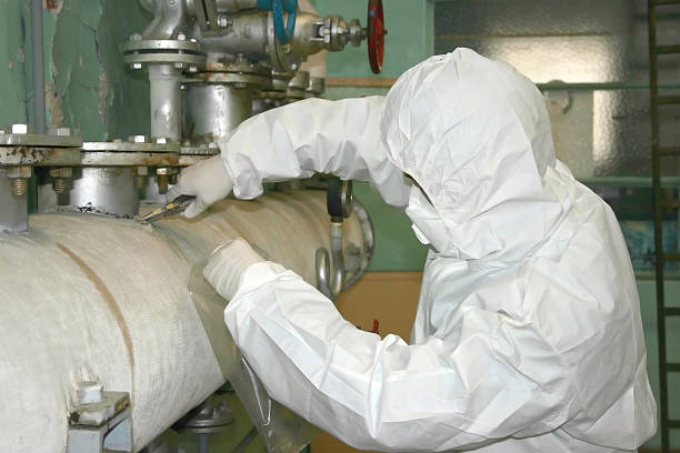 An asbestos removalist safely handling hazardous materials, demonstrating the need for asbestos testing and expert asbestos testing services.